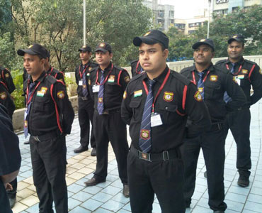 Team of United security guards lined up at a building complex
